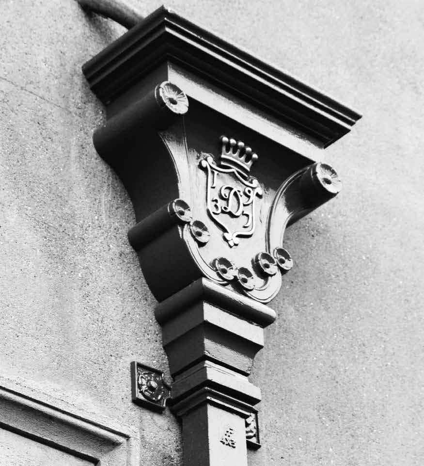 A cast iron hopper with a square downpipe